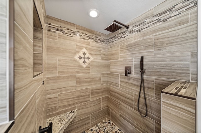 full bathroom featuring tiled shower