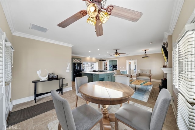 dining space featuring visible vents, crown molding, baseboards, and light tile patterned floors