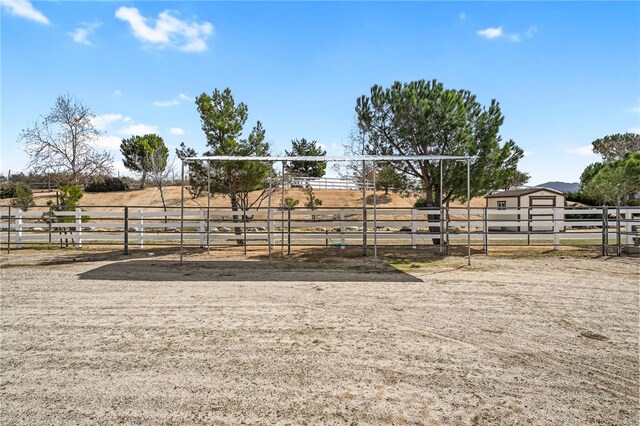 view of stable featuring a rural view