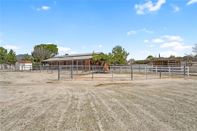 view of stable with a rural view