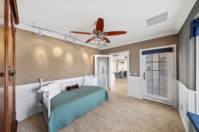 bedroom with ornamental molding, a wainscoted wall, visible vents, and track lighting