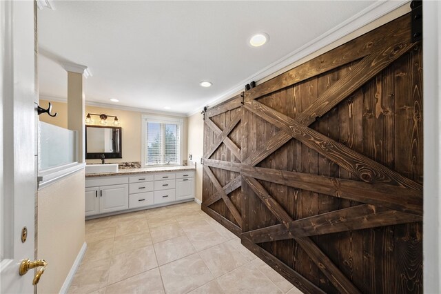 interior space with recessed lighting, vanity, ornamental molding, and tile patterned floors