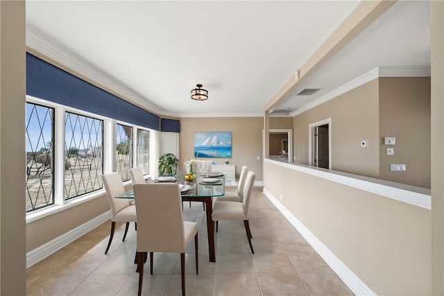 dining space with ornamental molding, visible vents, baseboards, and light tile patterned floors