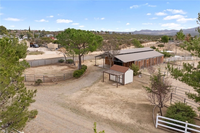 birds eye view of property with a mountain view and a rural view