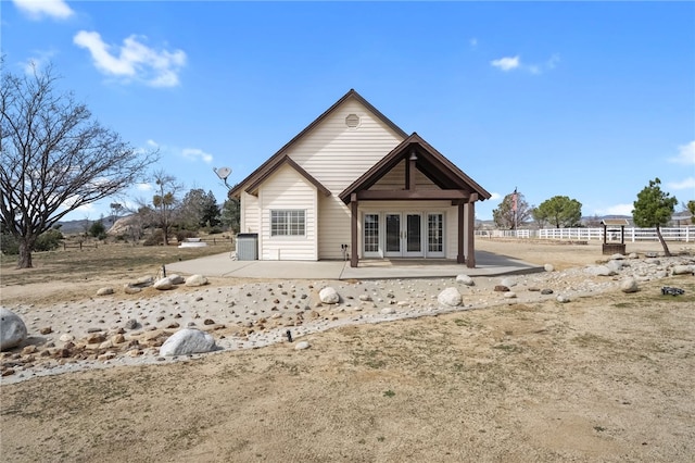 rear view of house featuring a patio, french doors, and fence