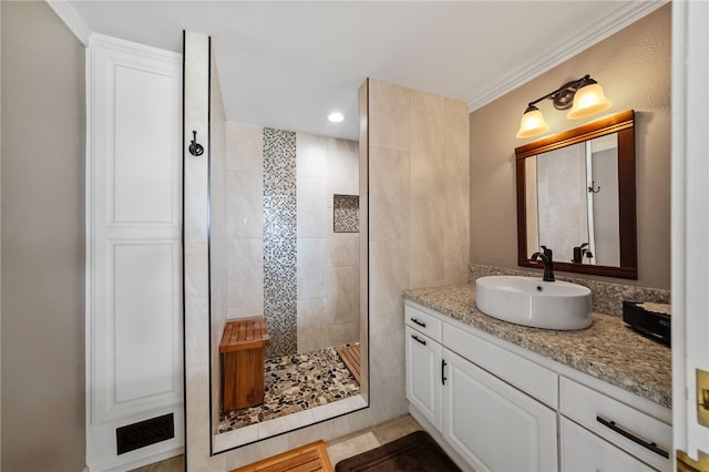 full bath featuring ornamental molding, a walk in shower, and vanity