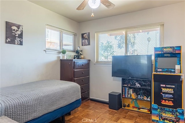 bedroom featuring ceiling fan and baseboards