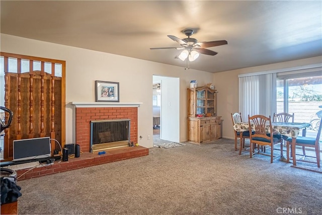 living area with carpet floors, ceiling fan, and a fireplace