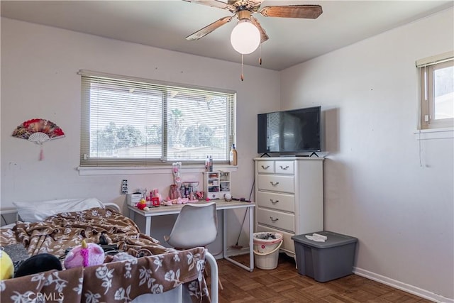 bedroom featuring ceiling fan, multiple windows, and baseboards