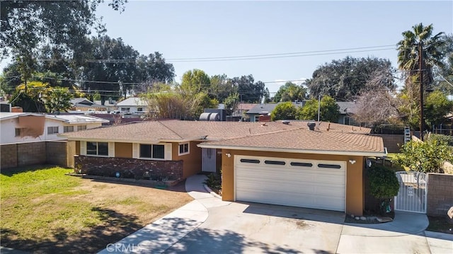 single story home with driveway, an attached garage, fence, and stucco siding