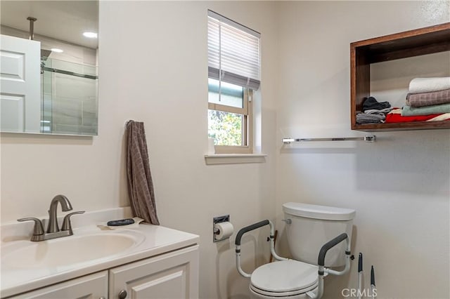 bathroom with toilet, an enclosed shower, and vanity