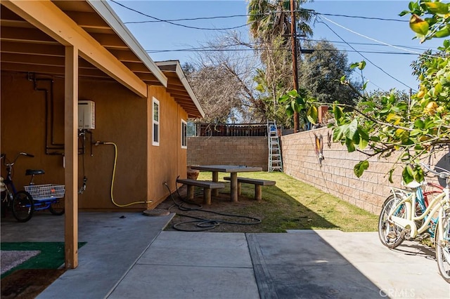 view of patio with a fenced backyard and water heater