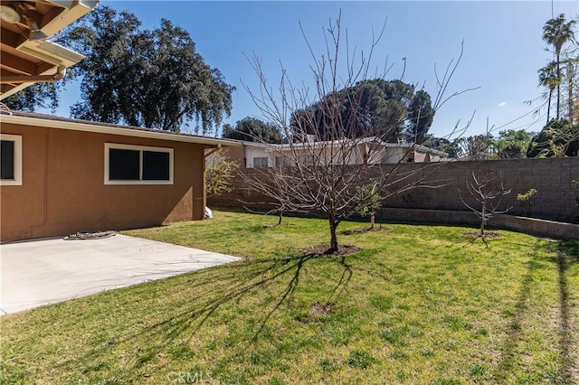 view of yard featuring a patio area and a fenced backyard