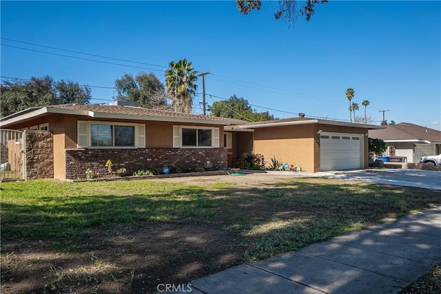 ranch-style home with a garage, concrete driveway, stucco siding, a front yard, and brick siding