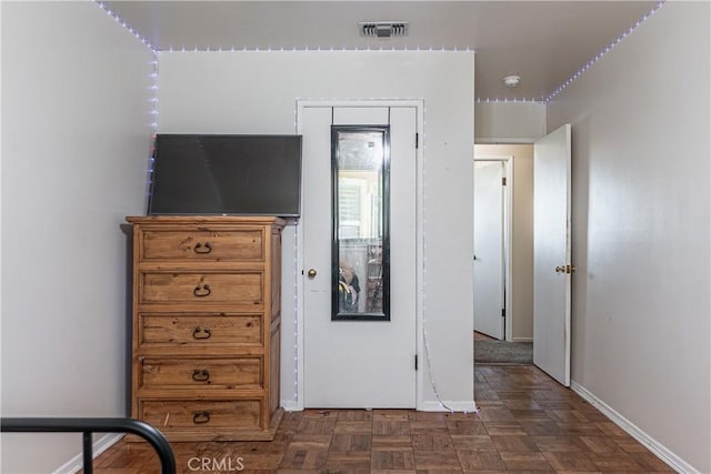 unfurnished bedroom with baseboards and visible vents