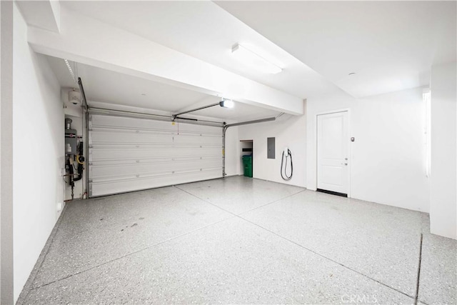 garage featuring electric panel and a garage door opener