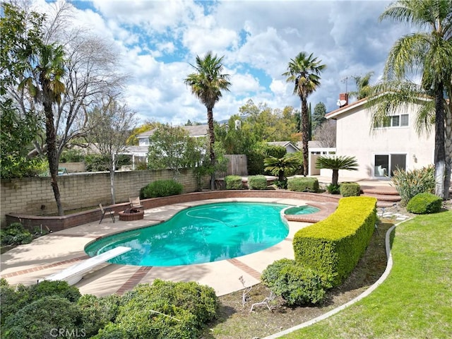 view of pool with a diving board, a patio, a fenced backyard, and a fenced in pool