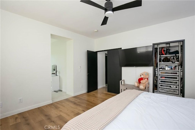 bedroom featuring wood finished floors, a ceiling fan, and baseboards