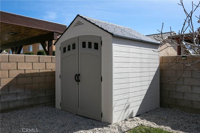 view of shed with fence