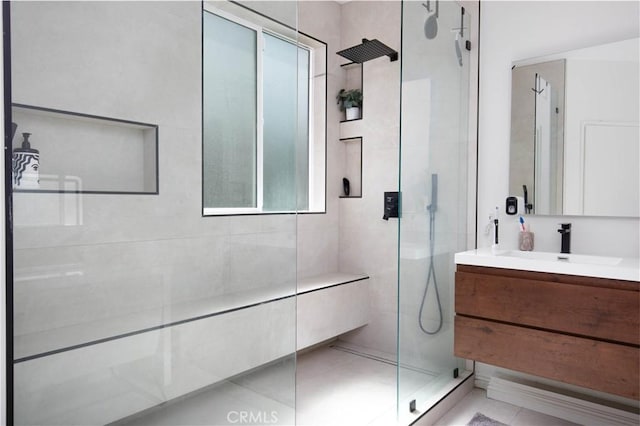 bathroom featuring a shower stall and vanity