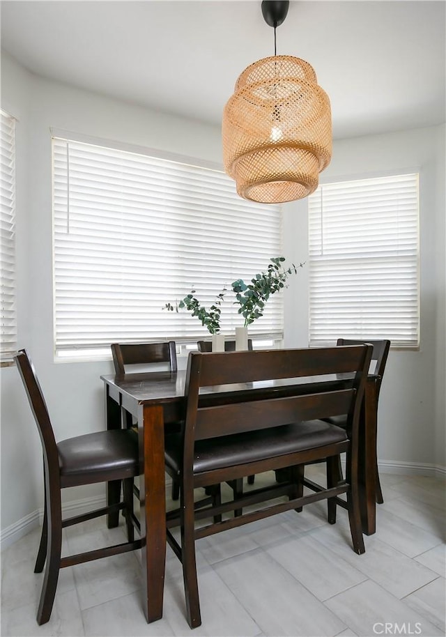 dining area featuring baseboards