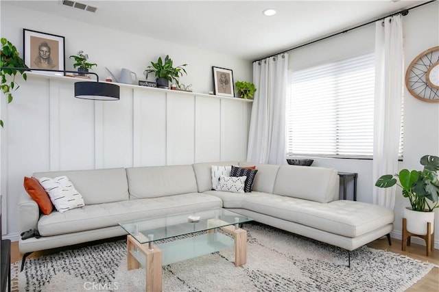 living room with wood finished floors, visible vents, and recessed lighting