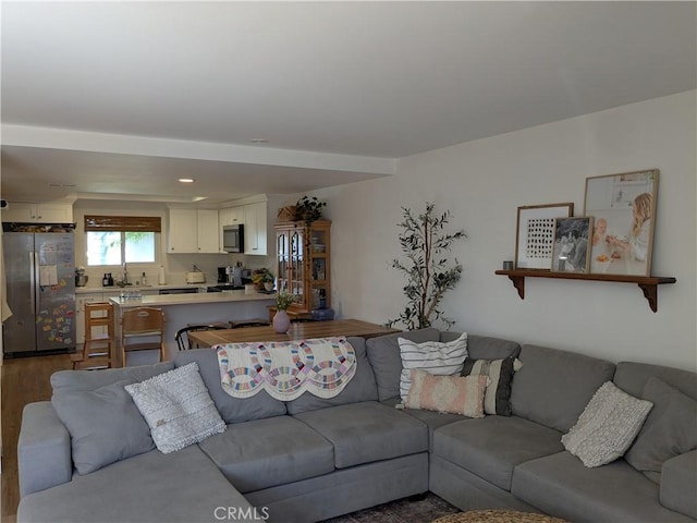 living room featuring dark wood-type flooring and recessed lighting