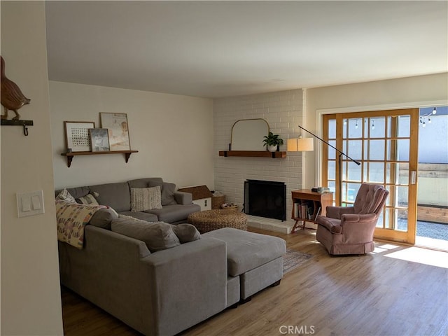 living room with a fireplace and wood finished floors