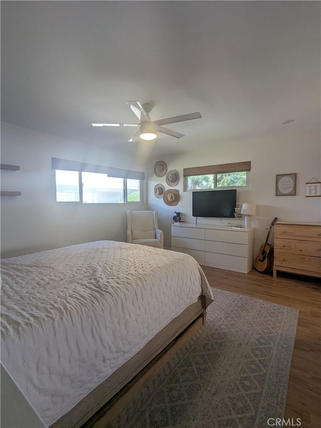 bedroom featuring a ceiling fan and wood finished floors