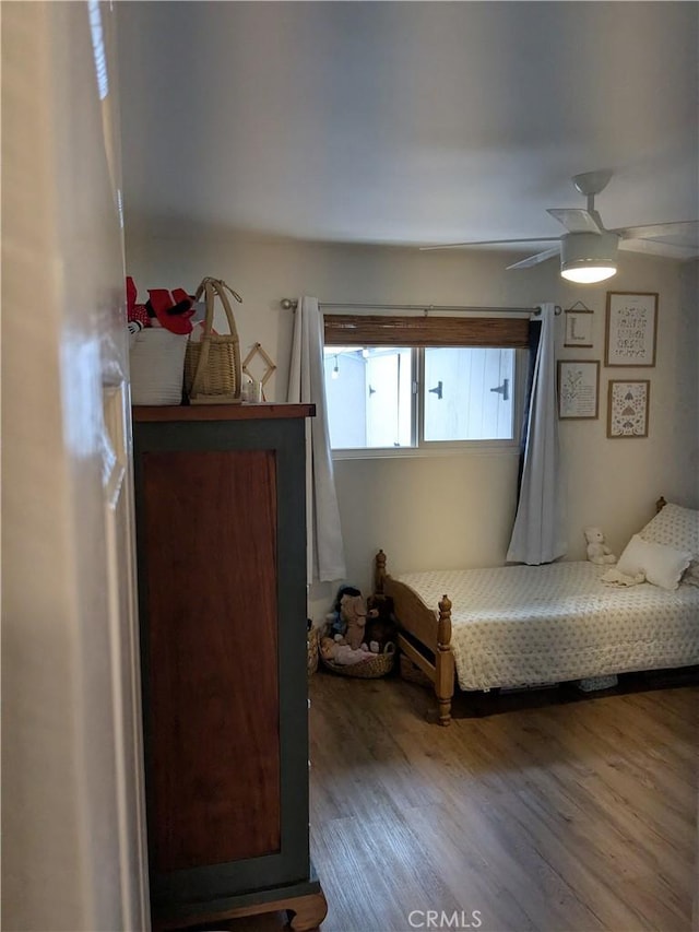 bedroom with ceiling fan and wood finished floors