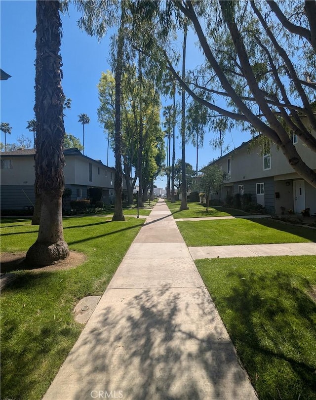 view of community featuring a lawn and a residential view