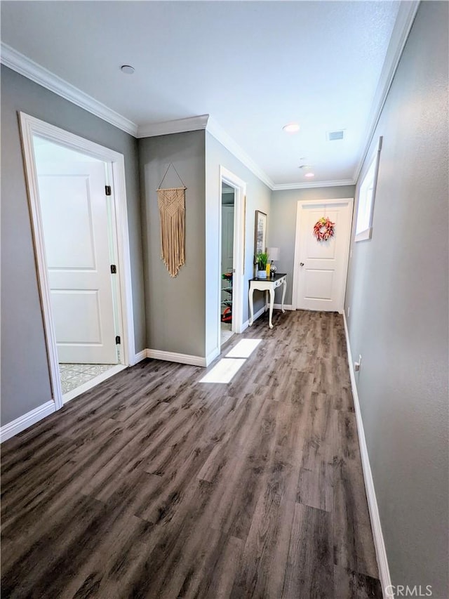 doorway to outside with ornamental molding, visible vents, and wood finished floors