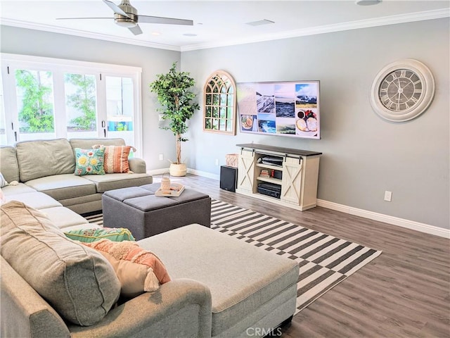 living area featuring a ceiling fan, crown molding, baseboards, and wood finished floors