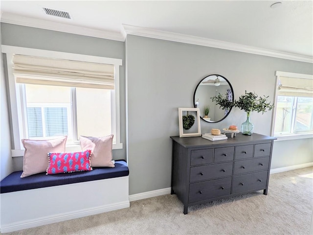 sitting room with light carpet, crown molding, visible vents, and baseboards