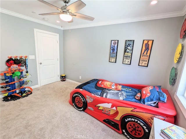 carpeted bedroom featuring ornamental molding, ceiling fan, and baseboards