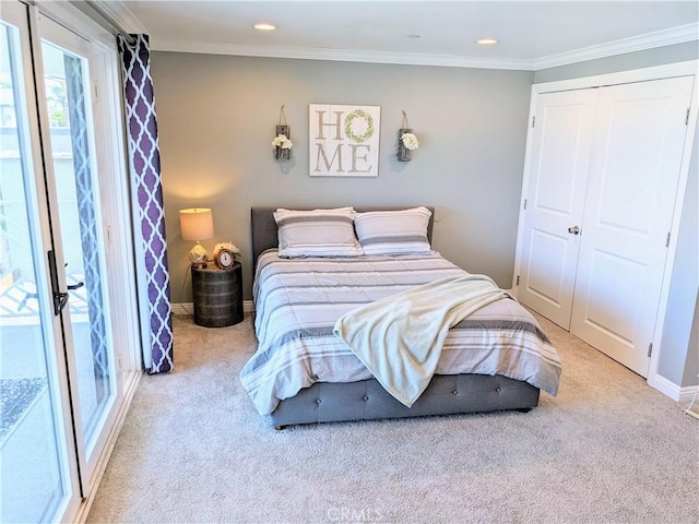 bedroom with carpet floors, a closet, ornamental molding, and baseboards