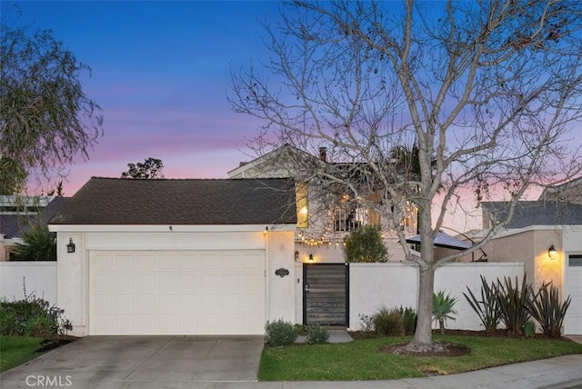 view of front of property featuring driveway, a garage, fence, and stucco siding