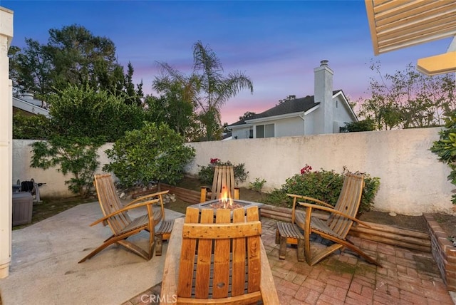 view of patio / terrace with a fenced backyard and a fire pit