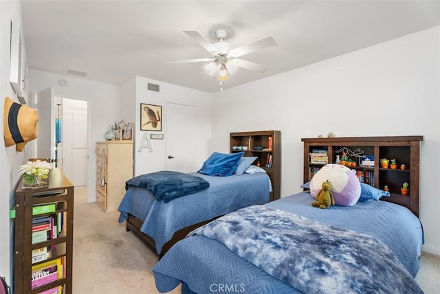 bedroom with ceiling fan, visible vents, and light colored carpet