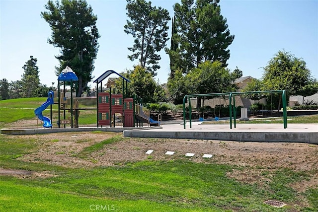 community jungle gym featuring a lawn