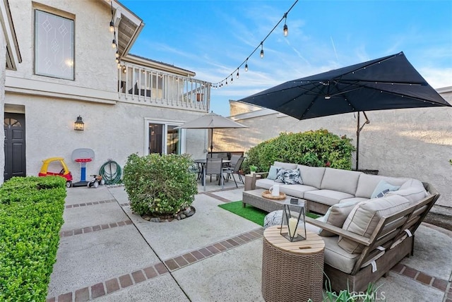 view of patio / terrace featuring outdoor dining area, a balcony, and an outdoor hangout area