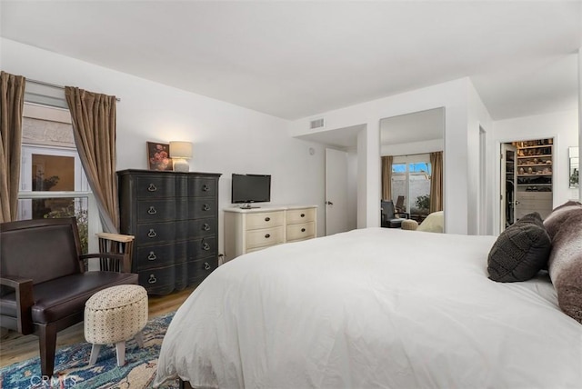 bedroom with wood finished floors and visible vents