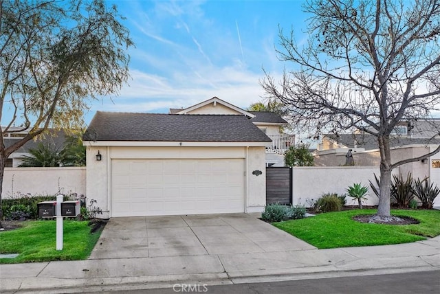 view of front of property featuring a front yard, stucco siding, driveway, and fence