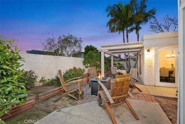 view of patio / terrace with a fire pit, fence, and a pergola