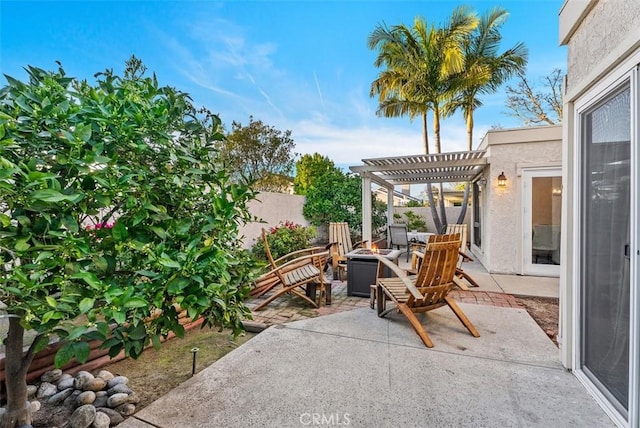 view of patio / terrace with fence, a fire pit, and a pergola