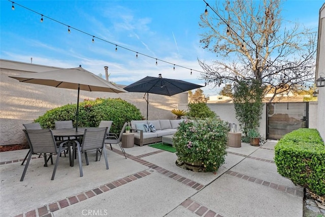 view of patio with fence, outdoor lounge area, and outdoor dining space