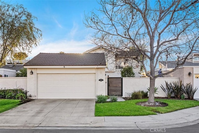 view of front facade featuring concrete driveway, an attached garage, a gate, fence, and stucco siding