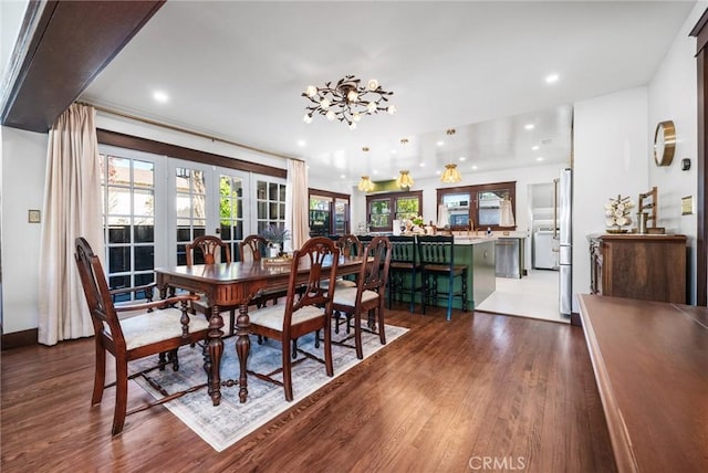 dining space featuring recessed lighting, dark wood finished floors, and french doors