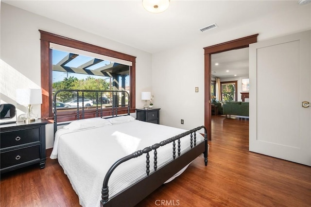 bedroom featuring visible vents and dark wood finished floors