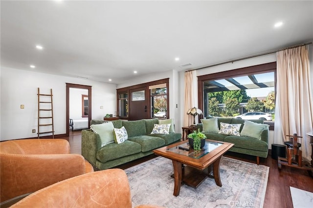 living area featuring recessed lighting, visible vents, and dark wood finished floors